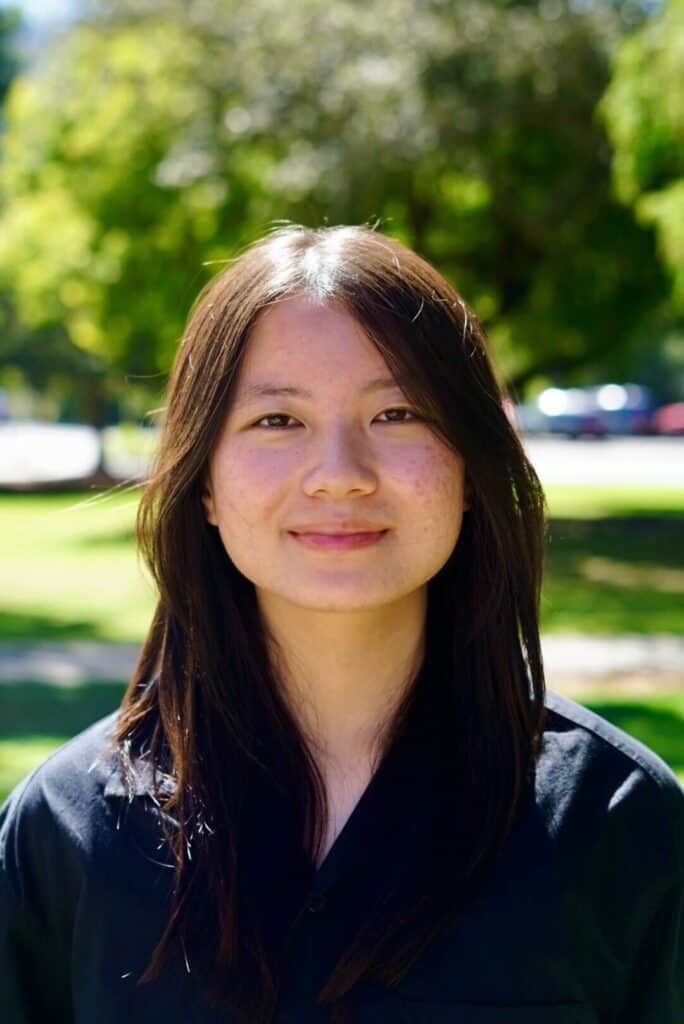 Melody Luo smiling outdoors at SuperTech FT, showcasing her involvement in technology and innovation.